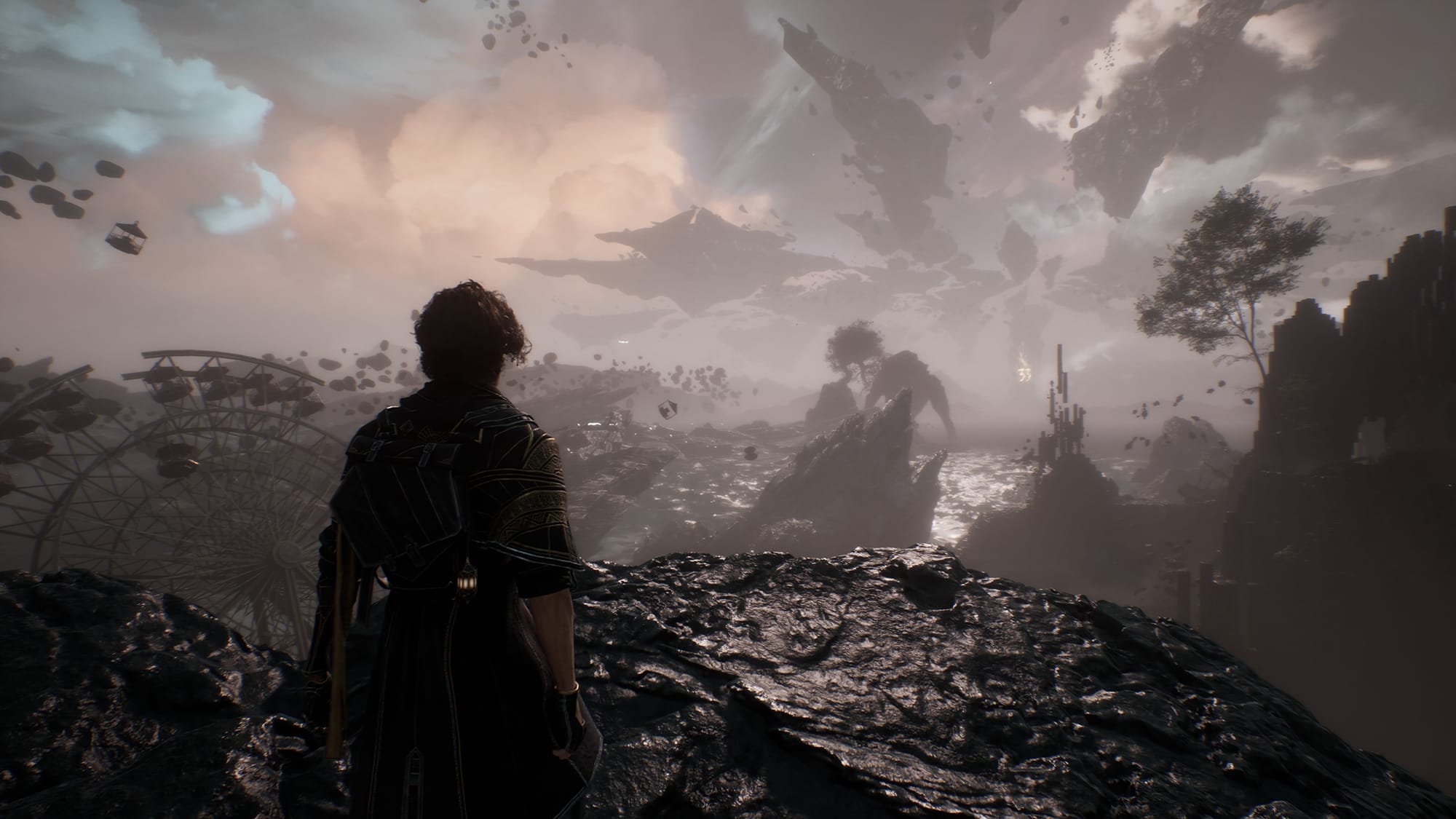A person standing on a cliff edge with shattered rock formations viewable in the distance