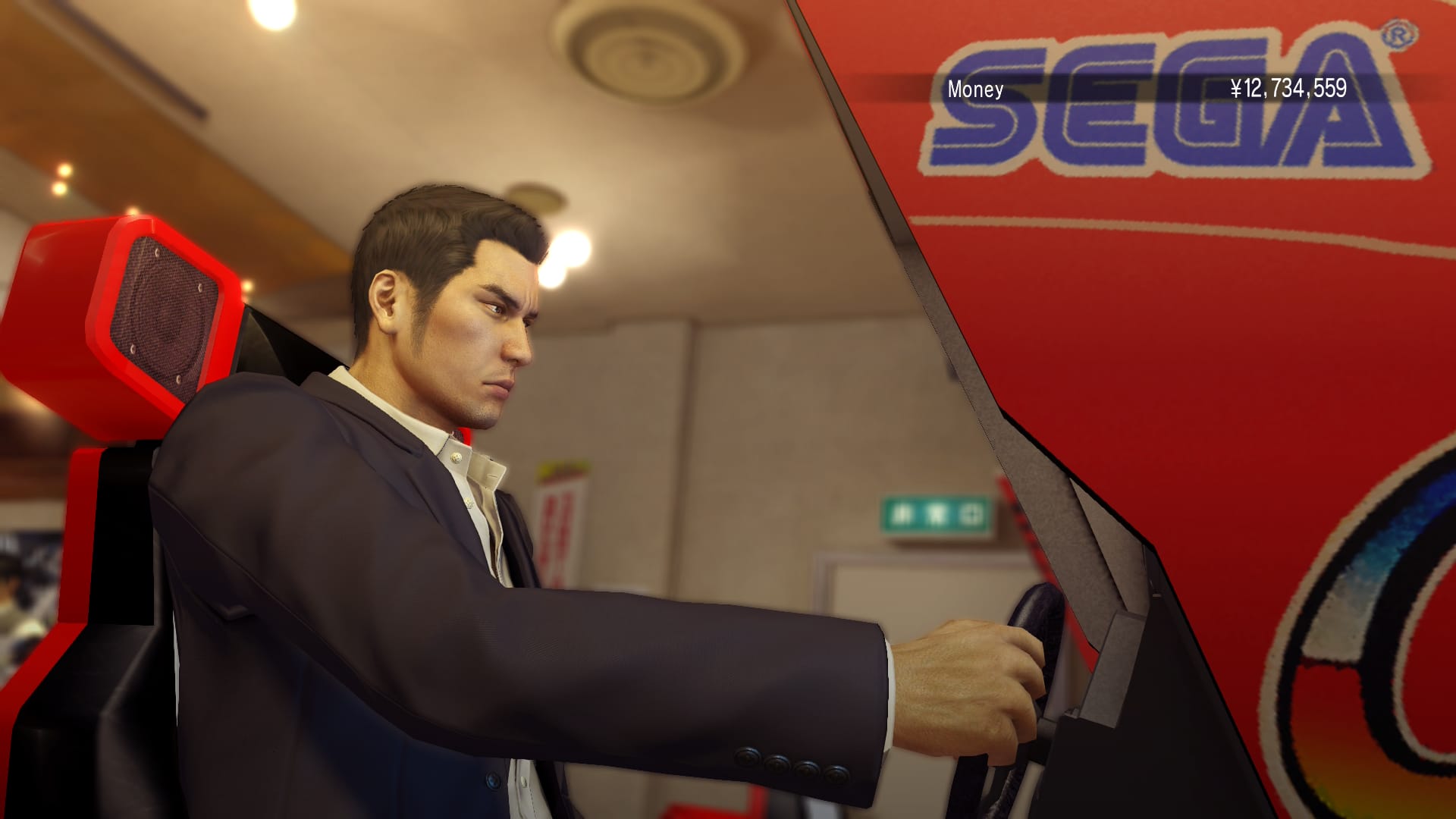 Kiryu sitting in an Outrun arcade machine in Yakuza 0 Director's Cut.
