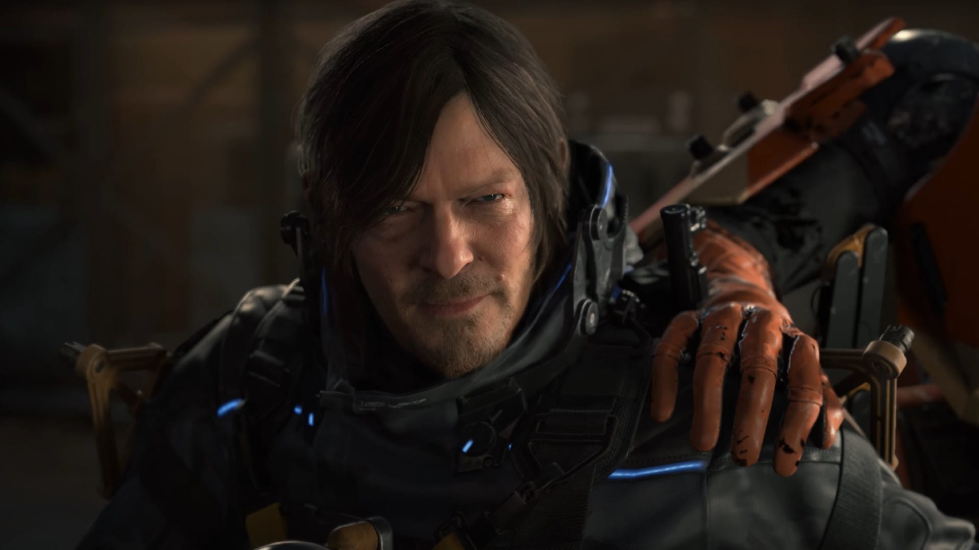 A lightly bearded guy with someone else's gloved hand on his shoulder