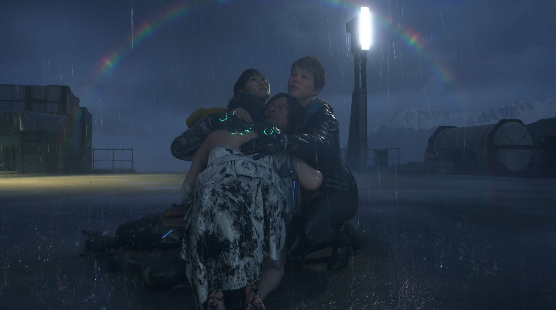 Fragile (Lea Seydoux), Rainy (Shioli Kutsuna) and Tomorrow (Elle Fanning) hugging Sam (Norman Reedus) in the rain.