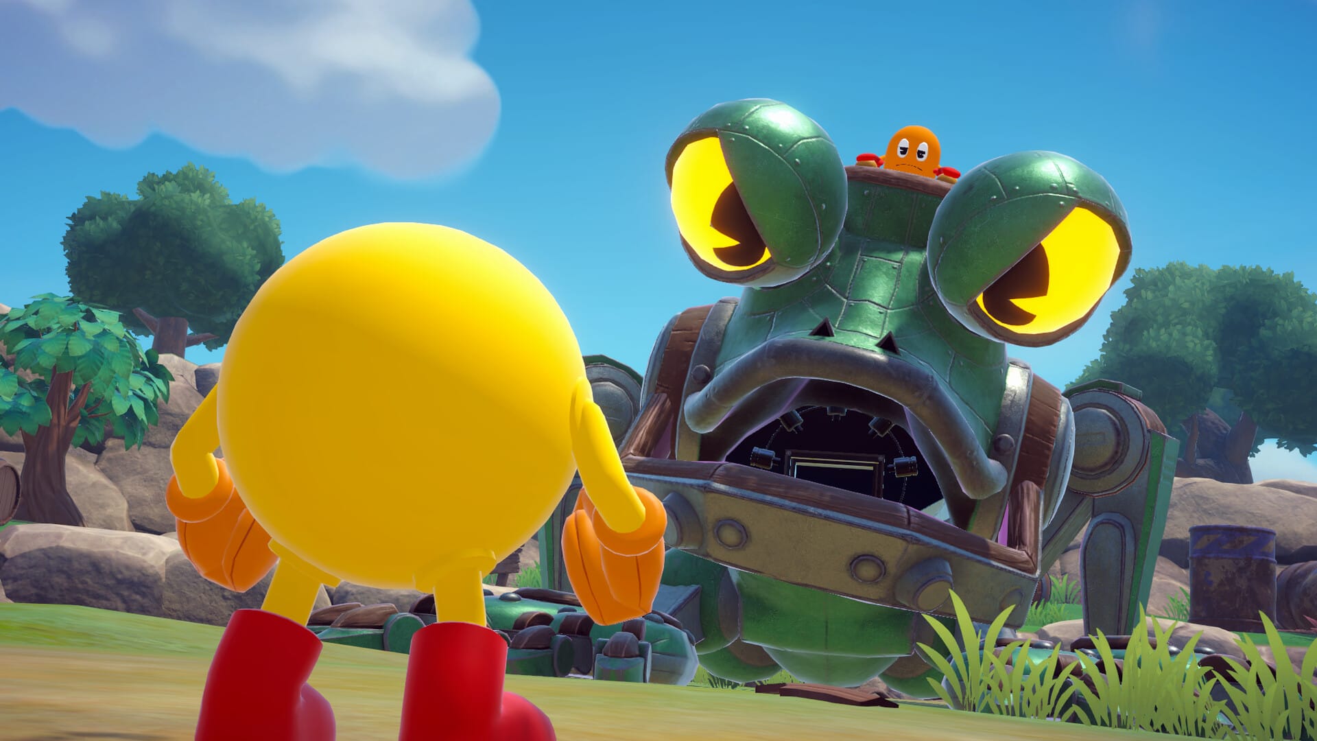 A green mechanical frog controlled by an orange ghost staring down Pac-Man